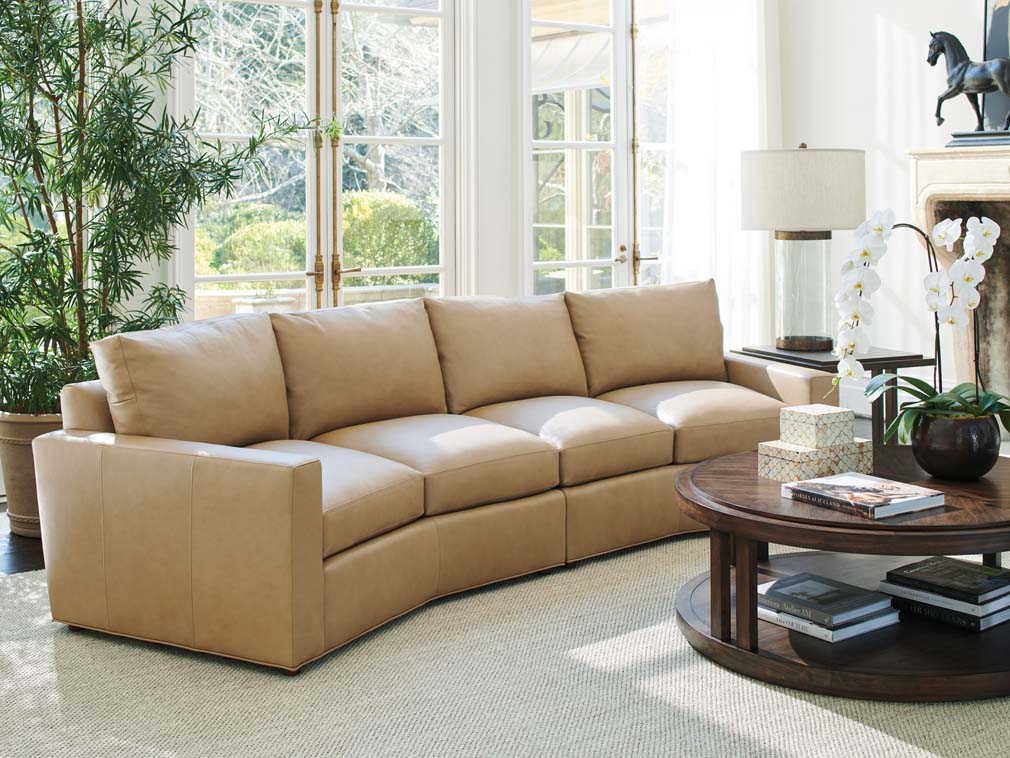 Curved leather sofa with four cushions