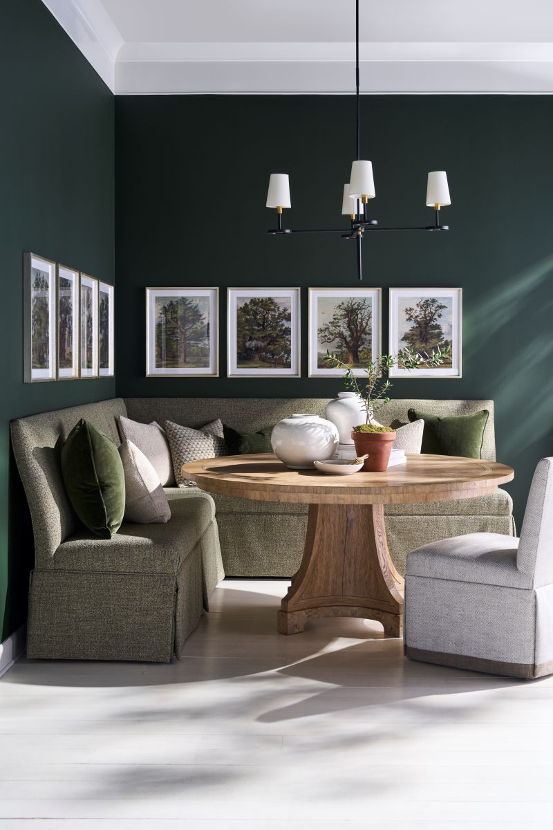 Round wood dining table with custom banquette seating in Denver home