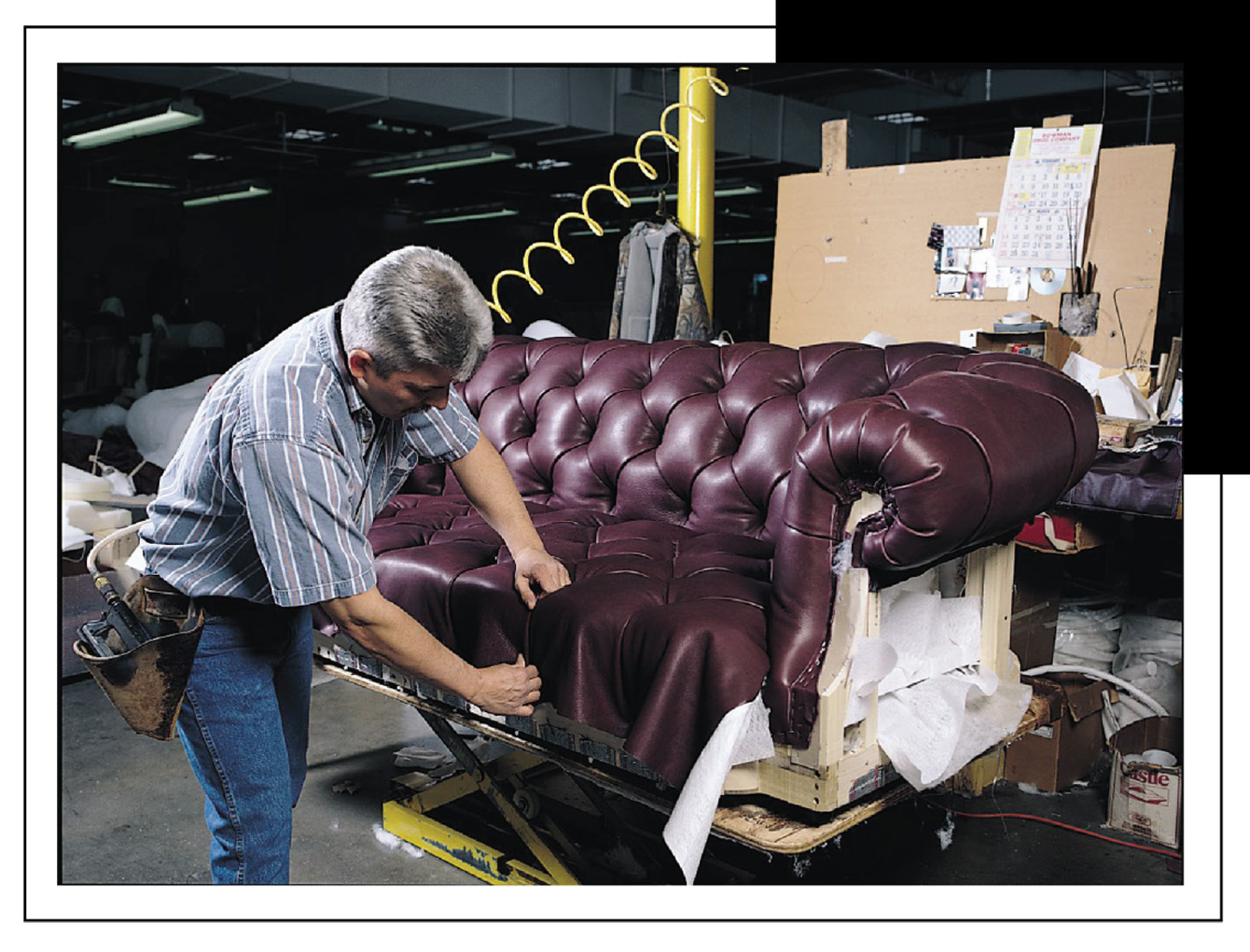 Worker building a leather sofa